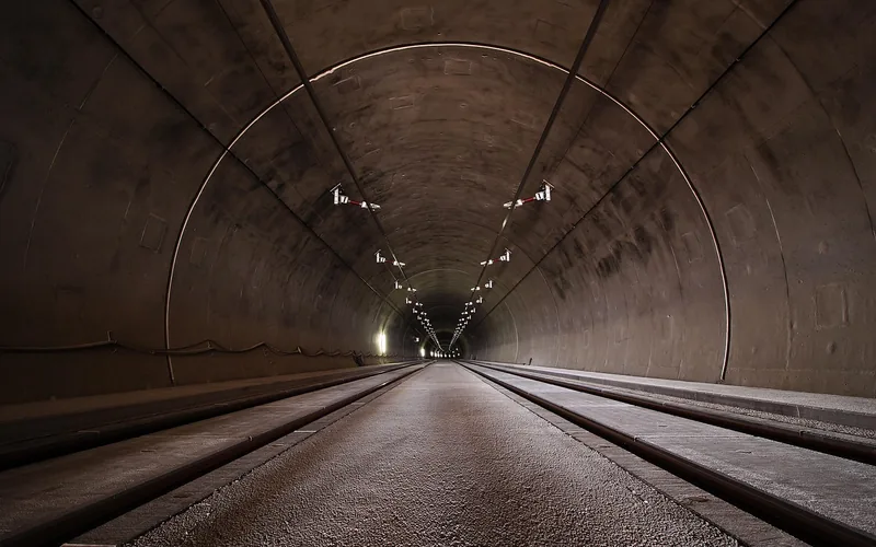 Long road tunnel with arched ceiling and lights