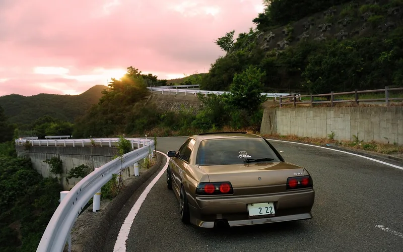 Nissan Skyline R32 driving on a mountain road, a JDM model once barred from US import