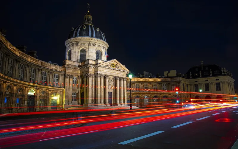 Paris street at night with long-exposure light trails