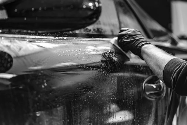 Washing a car with soapy water and a microfiber cloth to soften pitch