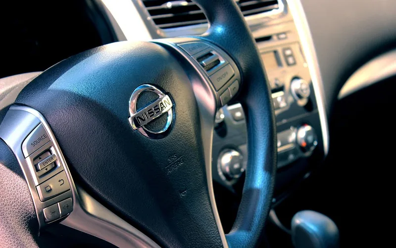Close-up of a sedan's steering wheel controls and center dashboard