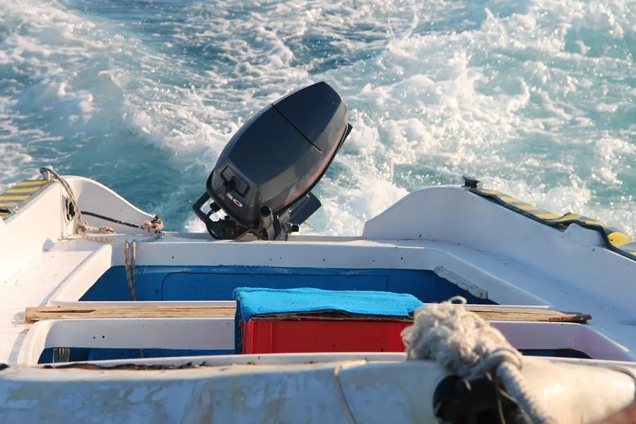 Outboard motor on the stern of a small boat