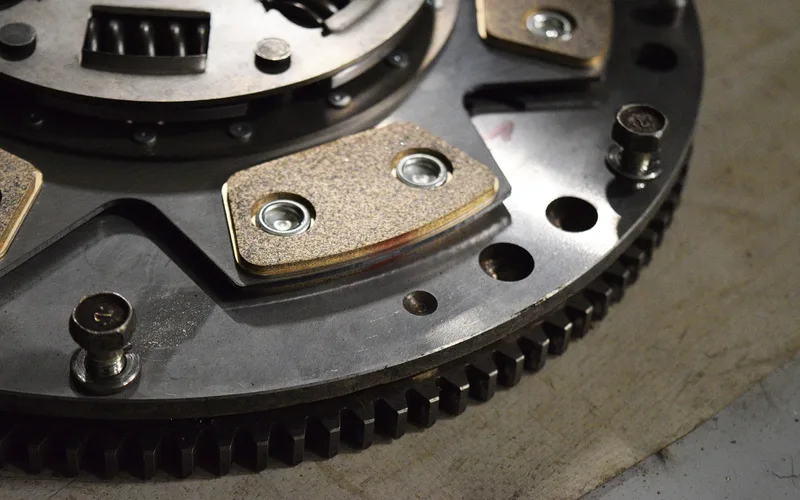 Car clutch disc and flywheel components removed for inspection