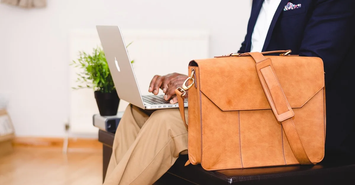 Laptop being packed into a padded carrying bag before leaving the car