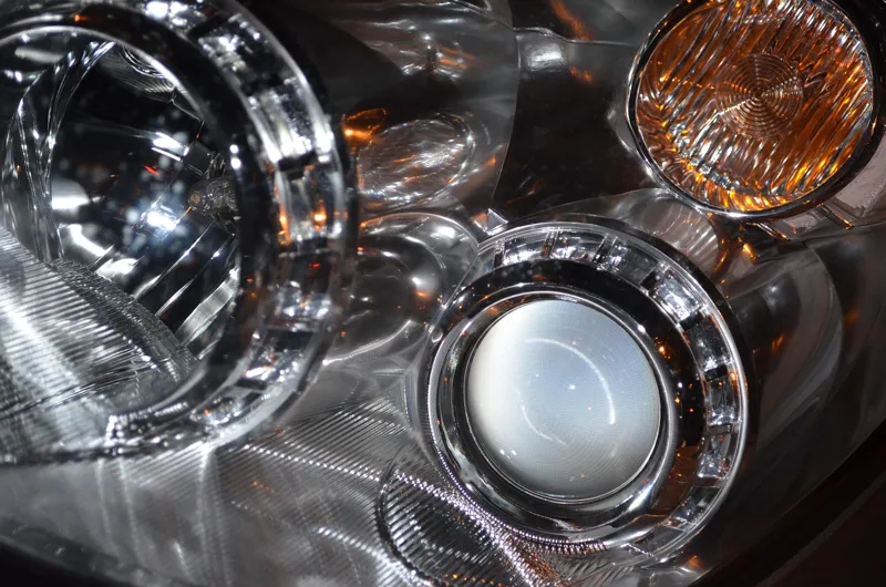 Car headlight cluster with an amber turn signal lens