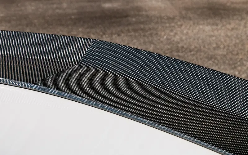 Carbon fiber weave on the surface of a rear car spoiler