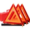 Three red and orange roadside warning triangles with a red carrying case
