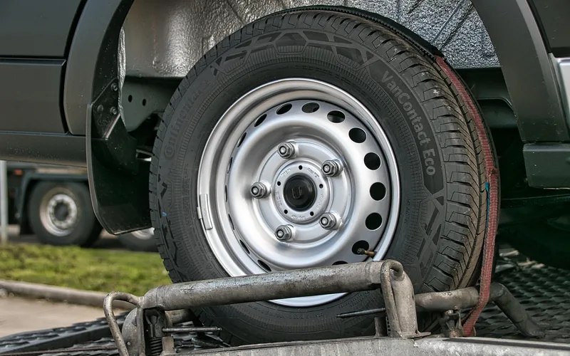 Car being loaded onto an enclosed trailer for transport