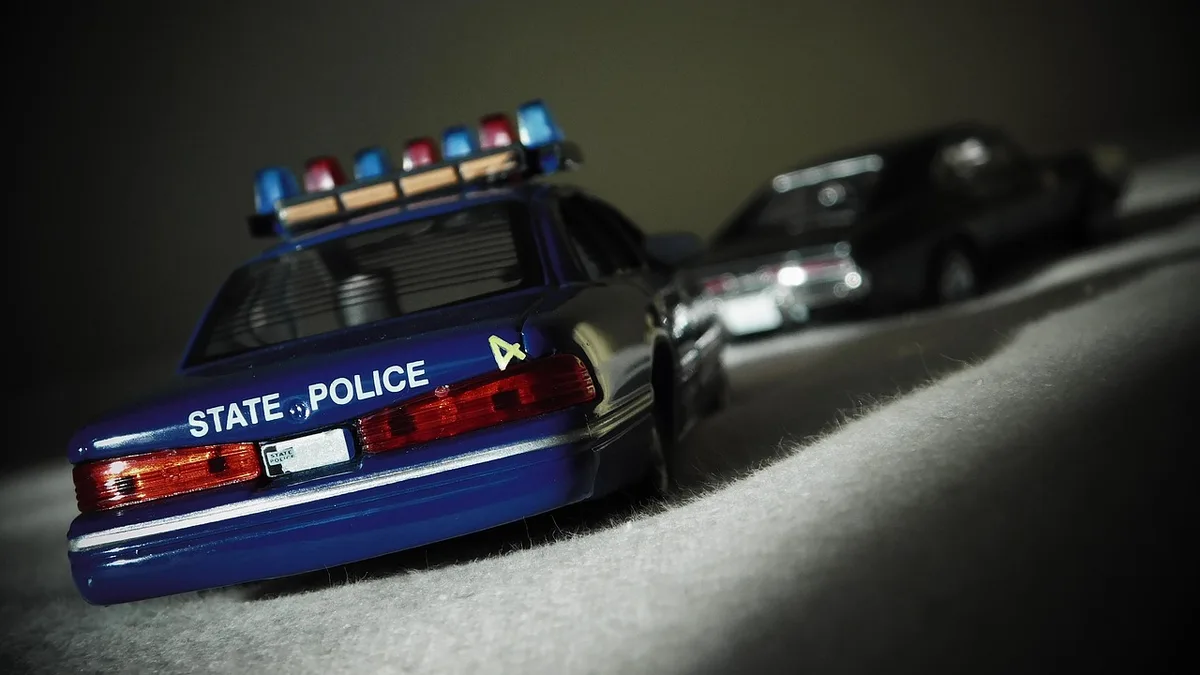 Police cars in pursuit during a highway chase.