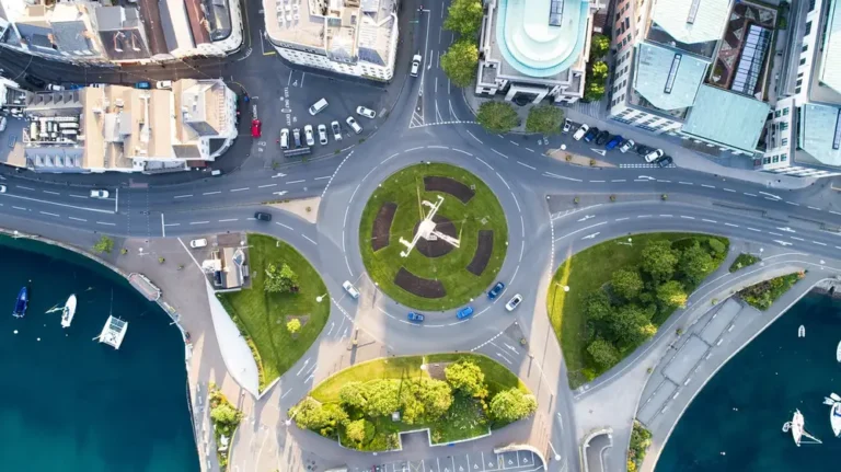Aerial view of cars driving around a roundabout in a town