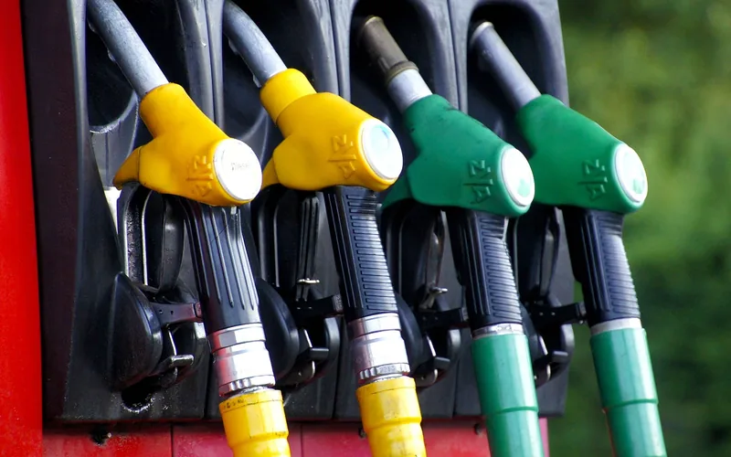 Filling a car's gas tank — the fuel gauge arrow tells drivers which side the fuel door is on before they even pull up to the pump
