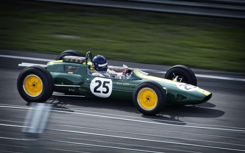 Open-wheel race car cornering on a speedway during a race
