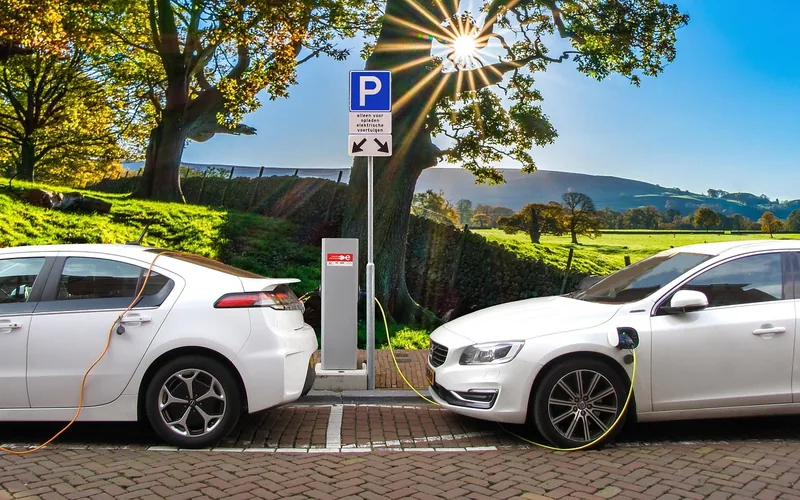 Plug-in hybrid car parked at a public charging post Plug-in hybrid car parked at a public charging post