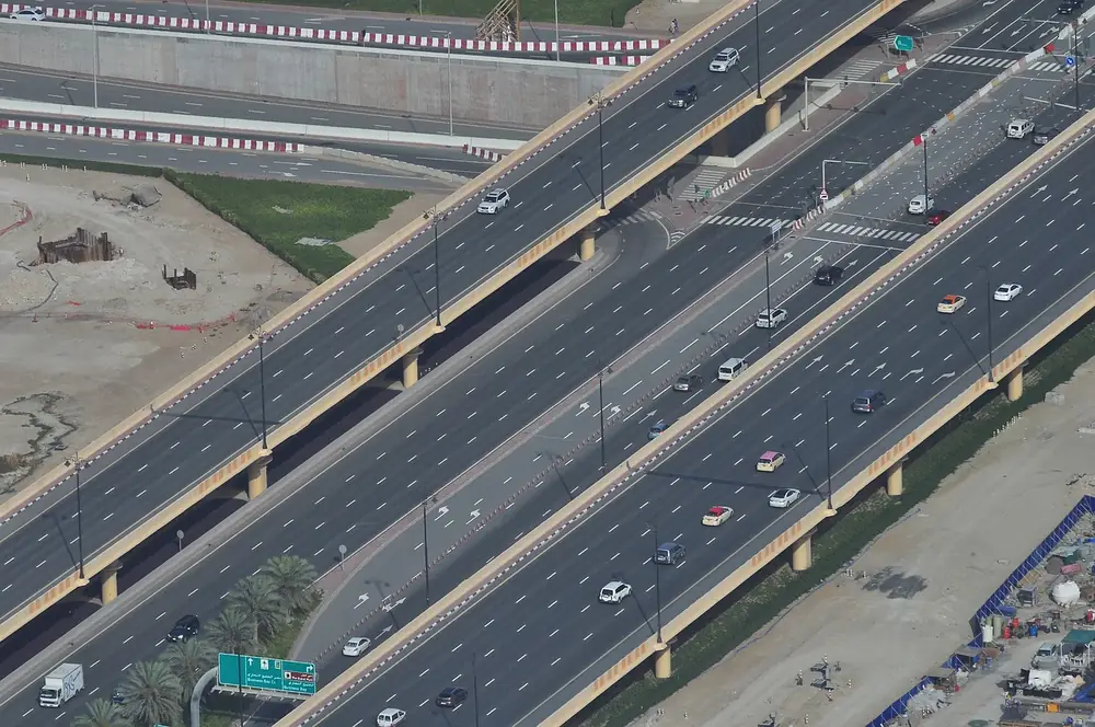 Aerial view of a multi-lane elevated highway with cars driving in both directions