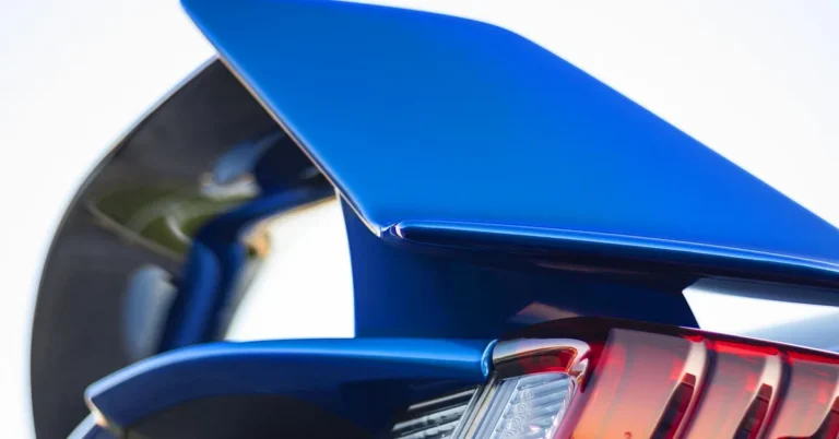 Close-up of a large rear wing on a blue sports car