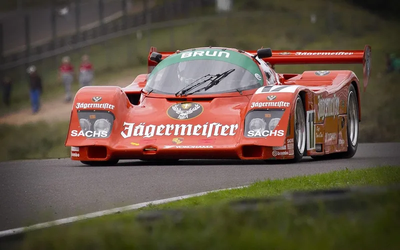A bright red race car speeding around a racetrack, similar to Lightning McQueen’s design