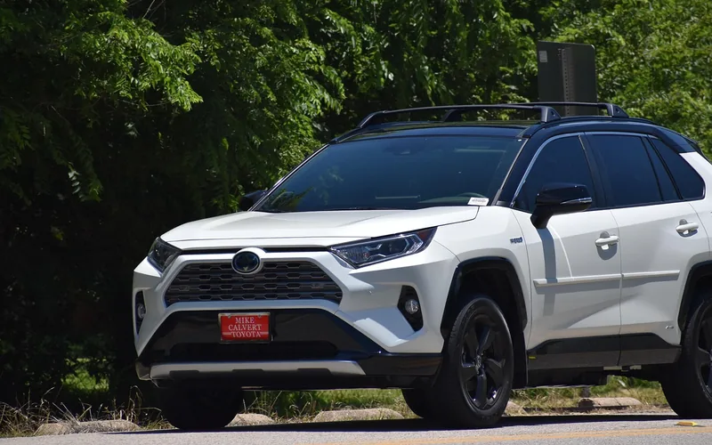 Self-charging hybrid SUV driving on a road without a charge cable Self-charging hybrid SUV driving on a road without a charge cable