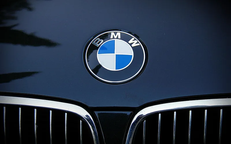 BMW roundel badge on the hood of a dark car above the kidney grille