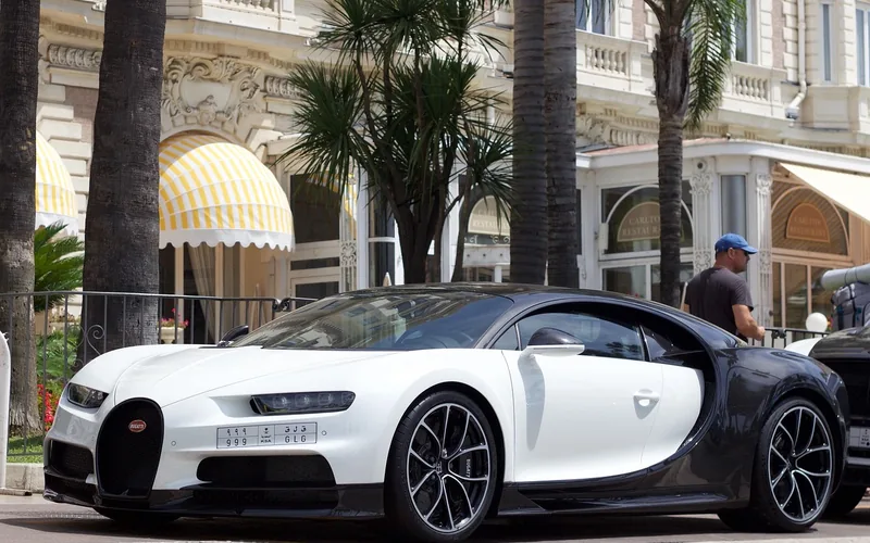 Bugatti hypercar on a city street, from the model lineage that led to the Tourbillon's 8.3-liter V16