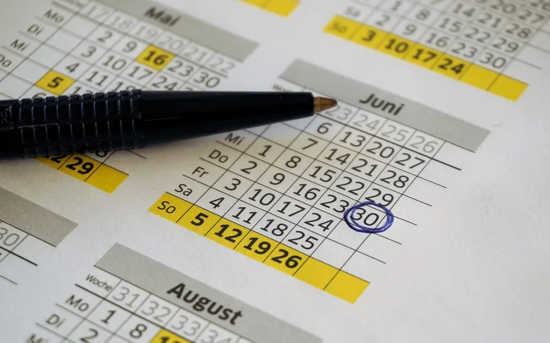 Printed calendar with the 30th of a month circled in blue pen