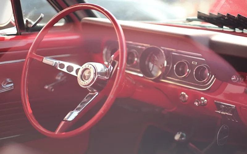 Car dashboard showing a fuel economy gauge