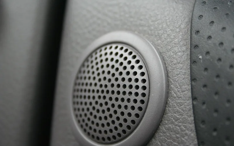 Car door speaker installed as part of a factory sound system Car door speaker installed as part of a factory sound system