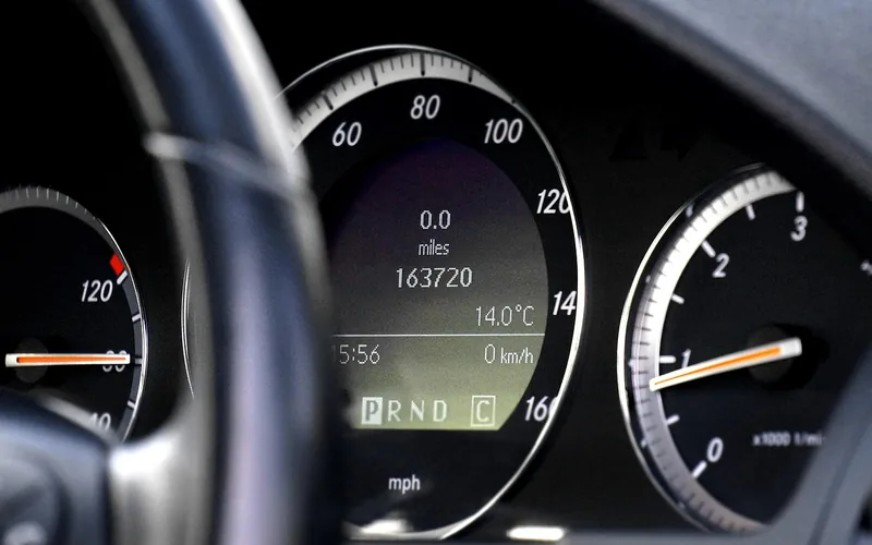 Car instrument cluster with a speedometer and a tachometer scale marked in thousands of revolutions per minute
