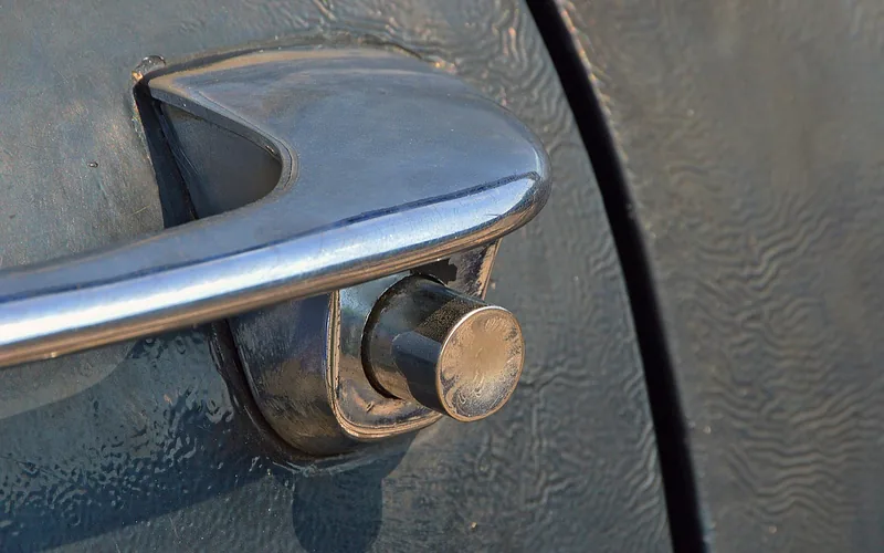 chrome push-button style exterior car door handle close-up chrome push-button style exterior car door handle close-up