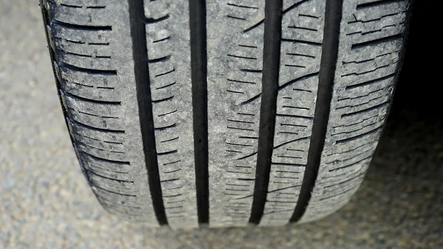Close-up of a car tire tread on pavement
