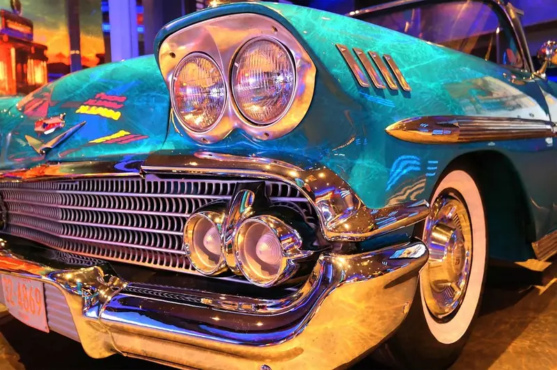 Close-up of a vintage car front end with a chrome grille and round headlights