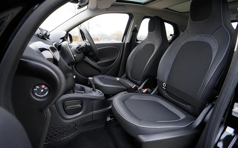 Clean gray car seat interior before a transparent plastic seat cover is applied
