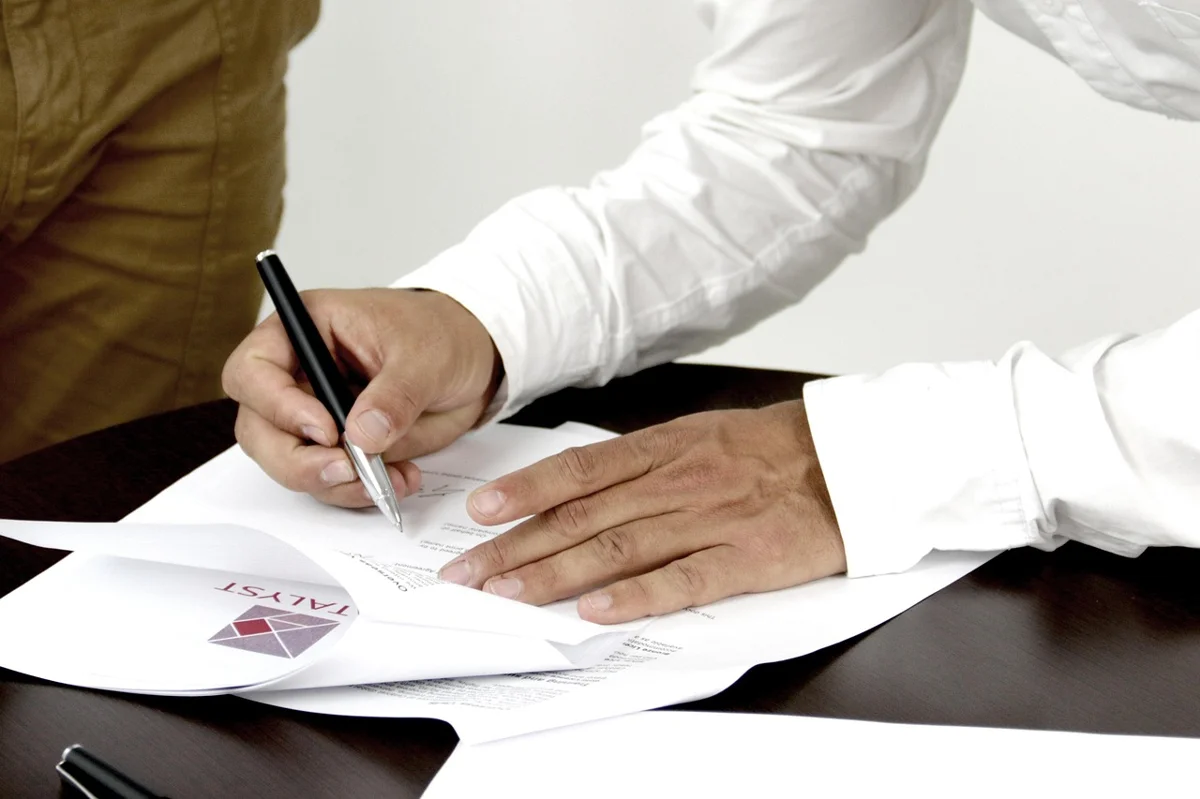 Customer signing a car rental agreement at the counter