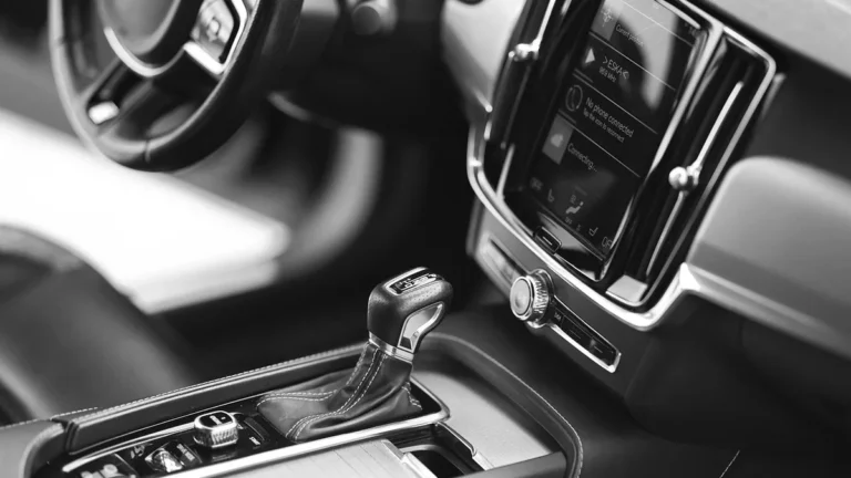 Touchscreen and gear selector on a modern car center console in black and white