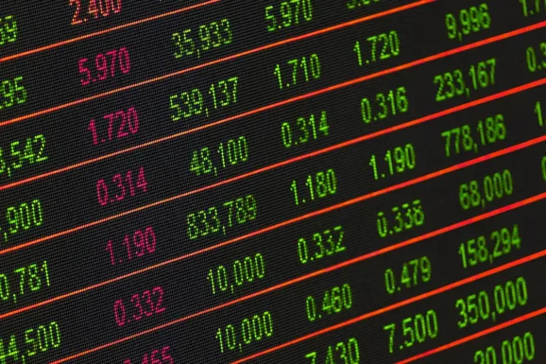 Close-up of a market data display showing rows of green and red figures