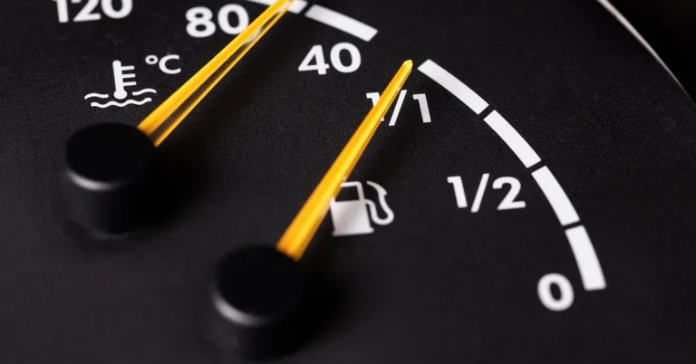Close-up of a fuel gauge needle near the full mark on a dashboard cluster