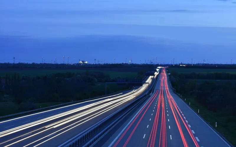 Highway at dawn with light trails from passing traffic