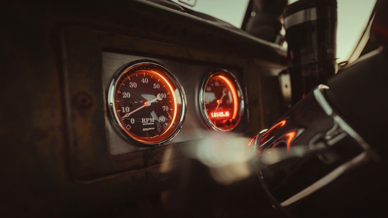 Close-up of engine RPM gauge needle on car dashboard
