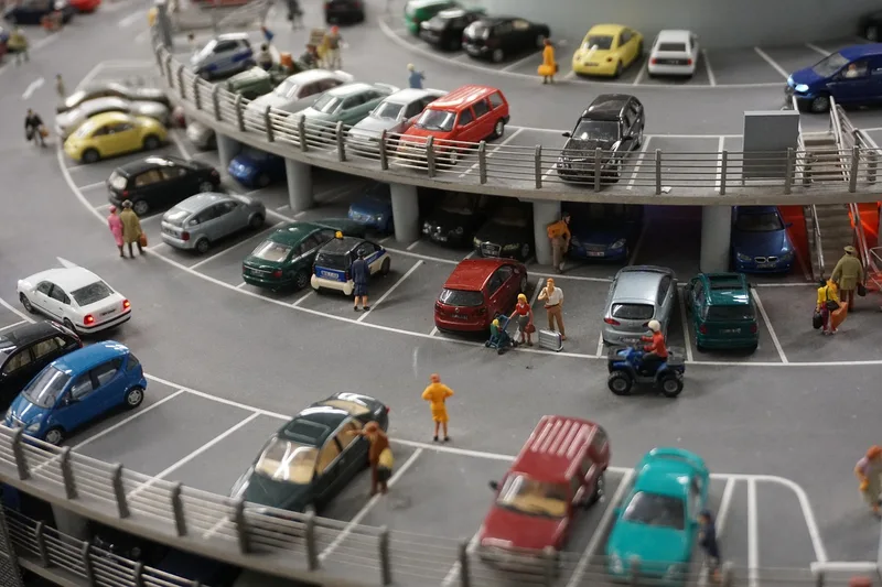Many miniature model cars in a multi-level car park scene