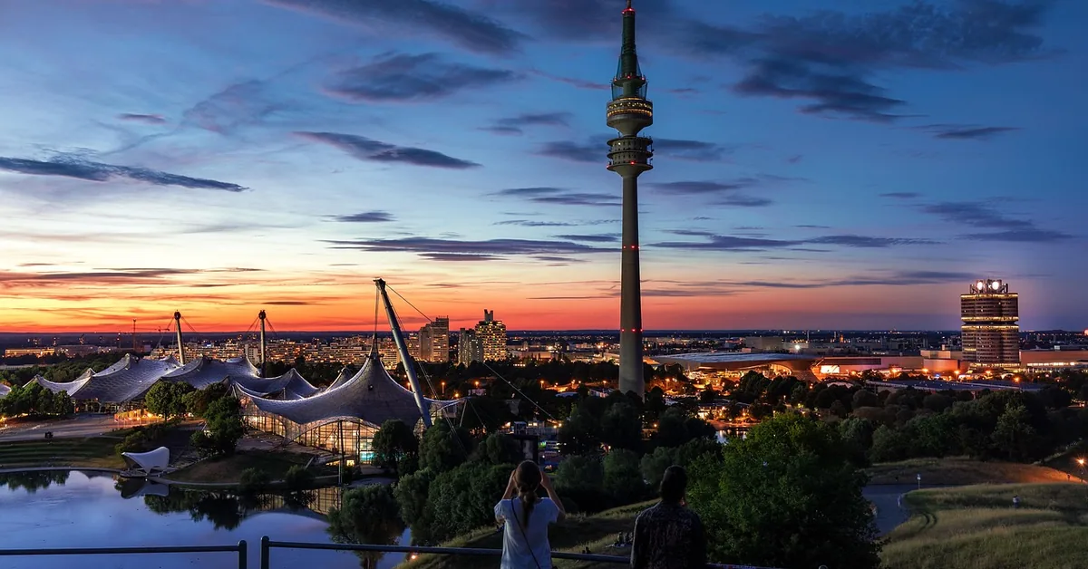 Munich skyline at dusk with the Olympic Tower and Olympic Park roofs