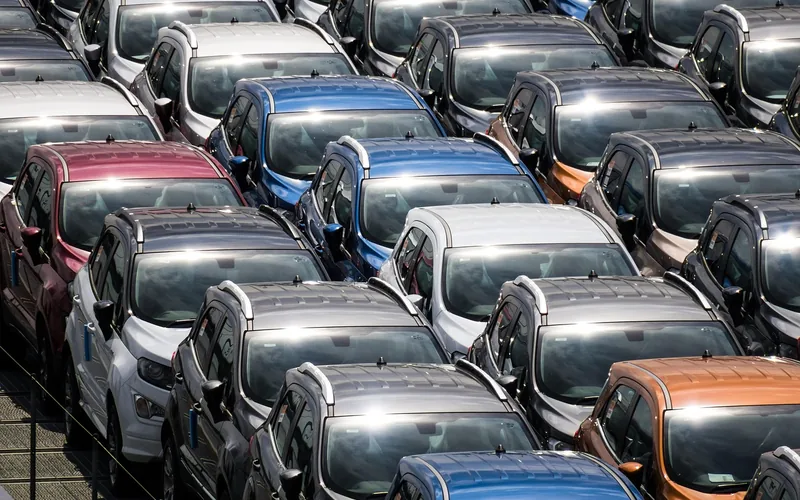 Rows of newly built cars parked at a factory lot awaiting export Rows of newly built cars parked at a factory lot awaiting export