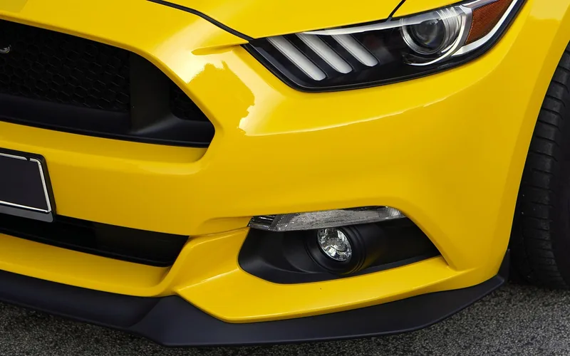 Close-up of a plastic car bumper and fender, the type of part that needs the right adhesive chemistry to repair