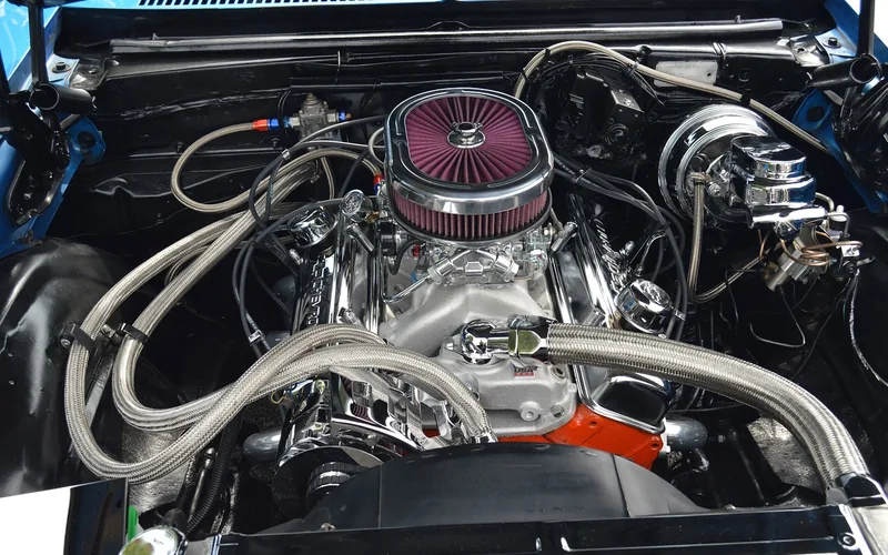 Chrome-polished large-displacement V8 engine block on display at a car show
