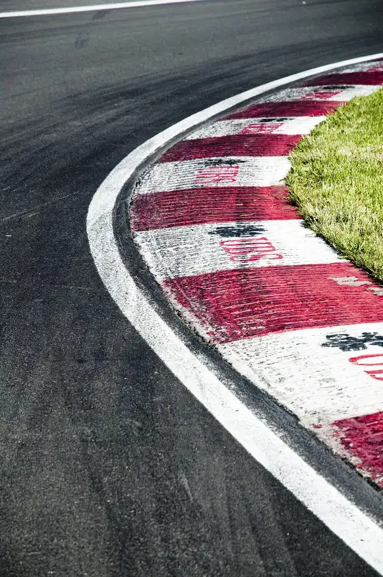 Red and white kerb on the inside of a race circuit corner