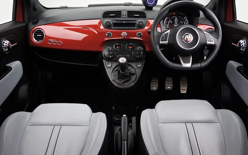 modern GT car interior with touchscreen infotainment and sport seats