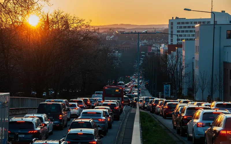 Rush hour traffic jam on a city road at sunset