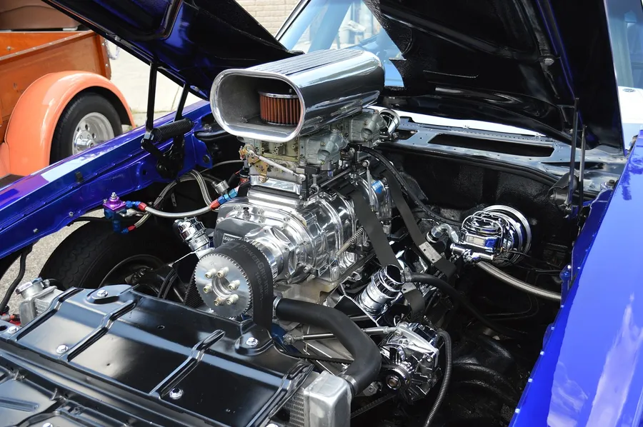 Chrome supercharger and carburetor on a custom hot rod V8 engine