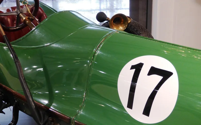 Cockpit and bodywork of a vintage green racing car carrying the number 17
