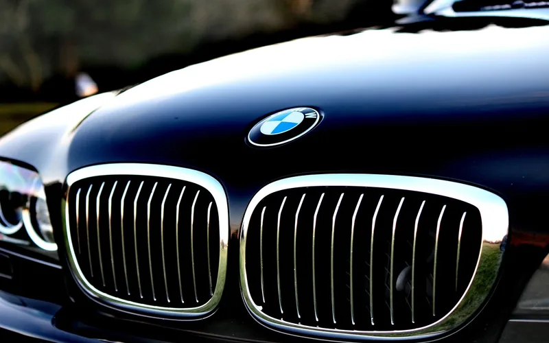 Close-up of a glossy black car hood on a modern vehicle Close-up of a glossy black car hood on a modern vehicle