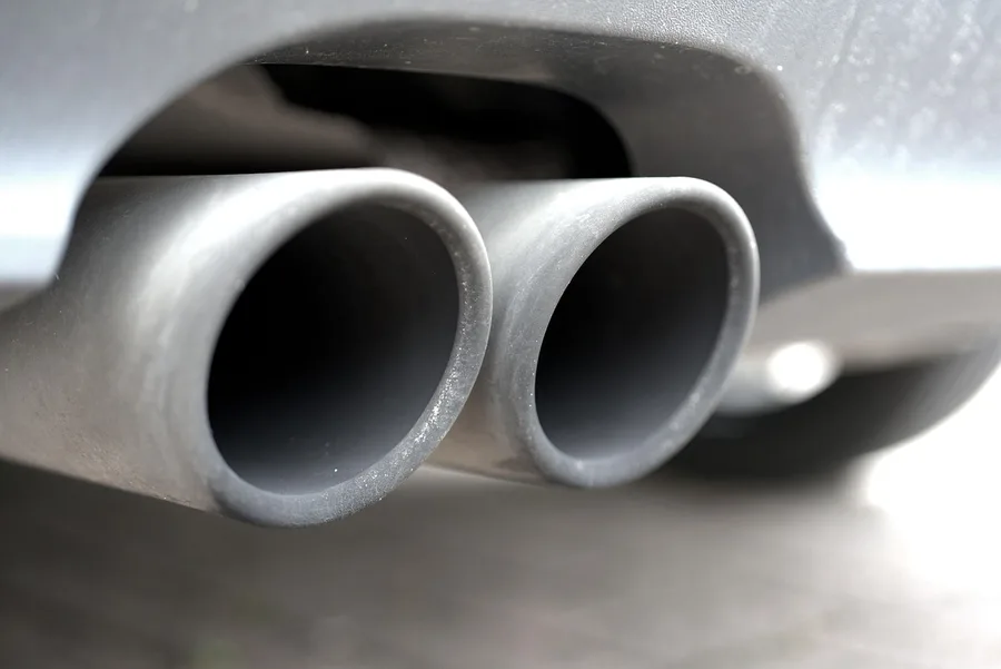 car exhaust tips releasing emissions while the engine idles