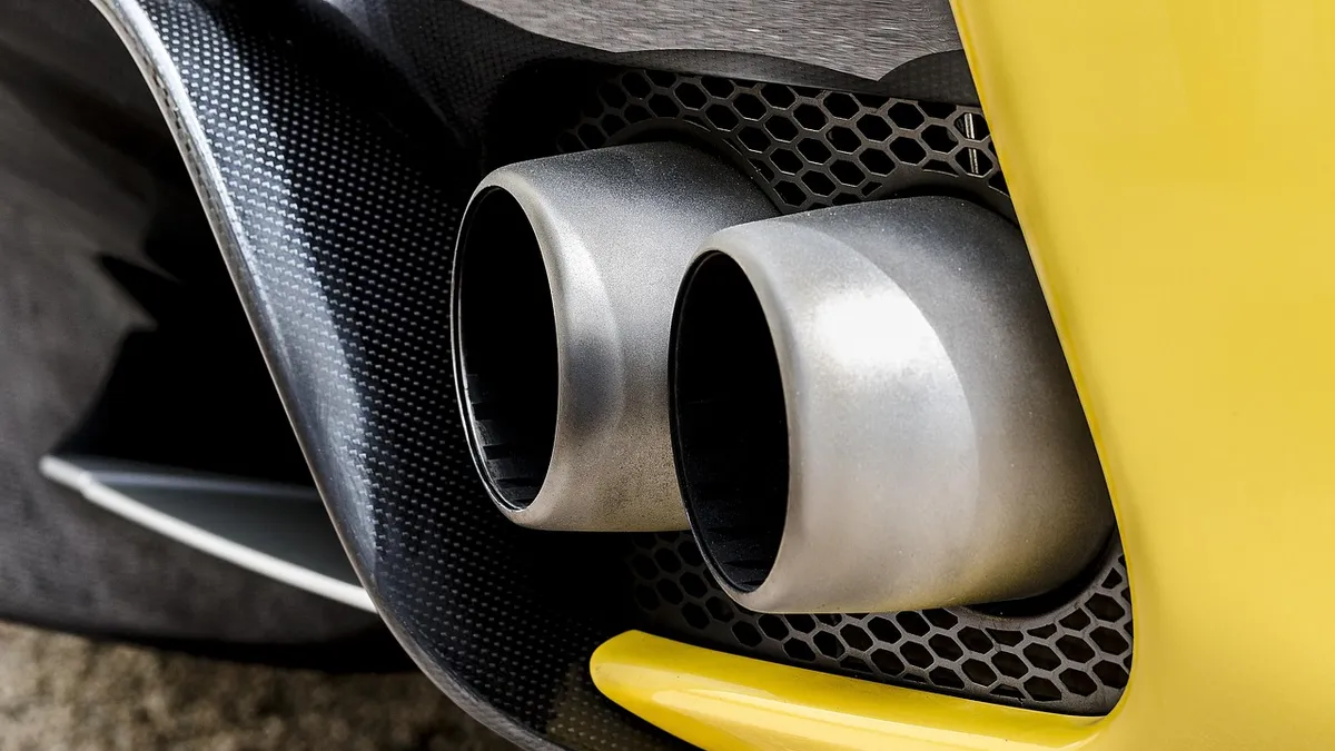 Car exhaust pipe releasing visible exhaust smoke linked to a failed emissions test
